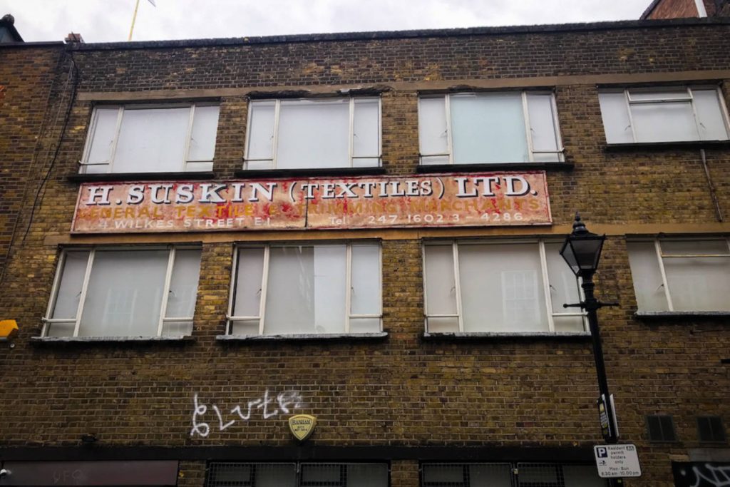 Sign of a textile wholesalers, ‘H. Suskins Textiles Ltd’, Spitalfields which opened in 1965 and closed in 2002, Bethnal Green.