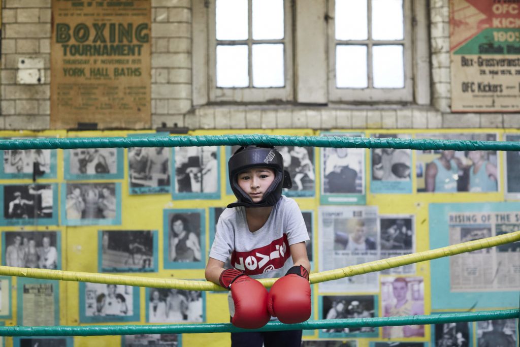 Young Repton Boxing Club member looks straight at the camera, Victorian Bath House, Bethnal Green.