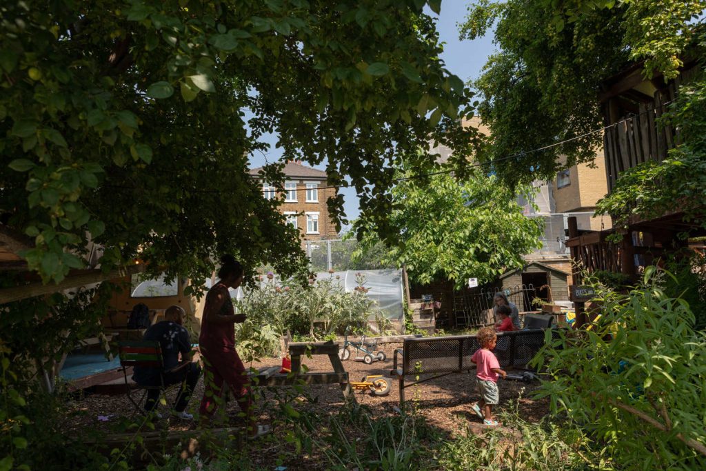 Families enjoying the green space at Spitalfields City Farm, Spitalfields.