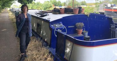Artist Milou Stella stands next to her house boat Baba Yaga on the canal
