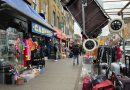 Walking through the streets of Bethnal Green with market stalls on the right.