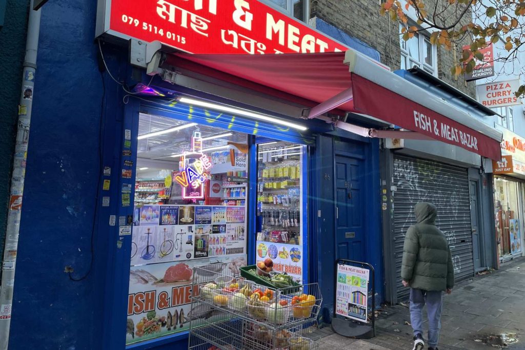 A Bethnal Green boy stops in front of THE Meat and fish bazar