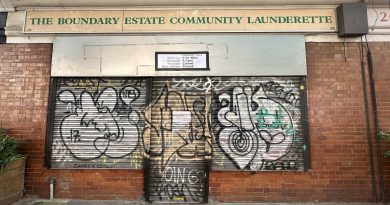 The Boundary Estate Laundrette shows new opening times on closed shutters.