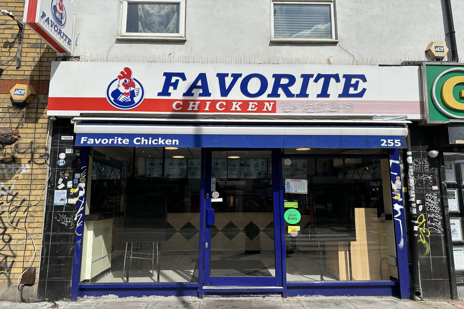 Bold blue lettered sign that reads Favorite's chicken on 255 Bethnal Green Road.
