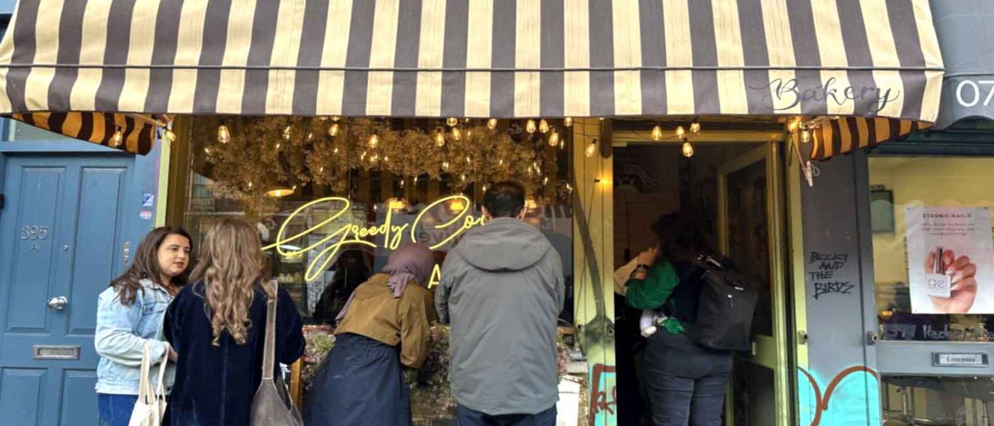 Customers queue outside Greedy Cow Bakery on Hackney Road at 11:30 AM.