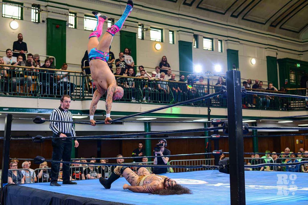 Lucha Libre wrestler doing a handstand on the rope of the wrestling ring
