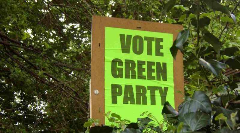 A 'vote Green Party' poster submerged in trees