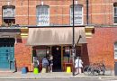 Leila's shop on Calvert Avenue on a sunny day, with customers sitting at pavement tables.